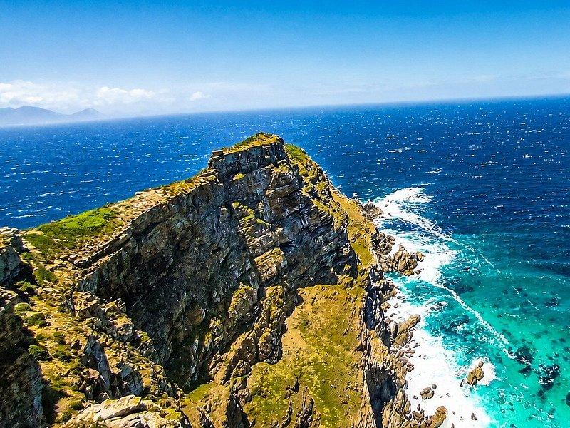 The headland at Cape Point from above, the surf breaking along its edge